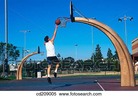 Man plays basketball on a neighborhood court View Large Photo Image Stock Photography - Man plays basketball on a neighborhood court. Fotosearch