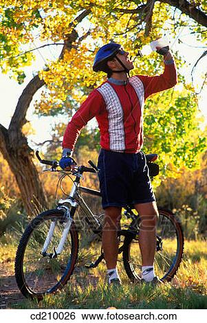 Man taking a break from mountain biking View Large Photo Image Stock Photograph - Man taking a break from mountain biking. Fotosearch