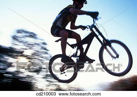Mountain biker gets big air on a jump View Large Photo Image Stock Image - Mountain biker gets big air on a jump. Fotosearch