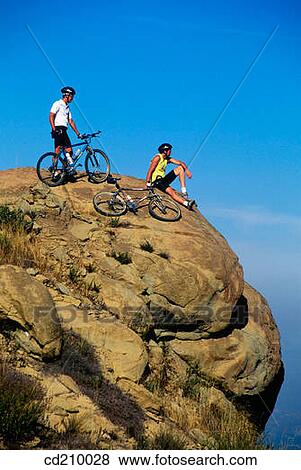 Mountain bikers on a cliff View Large Photo Image Stock Photo - Mountain bikers on a cliff. Fotosearch