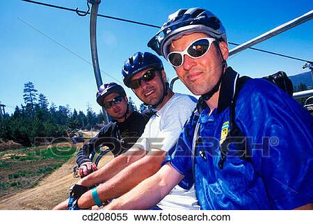 Mountain bikers riding the mountain ski lift up the hill View Large Photo Image Stock Photography - Mountain bikers riding the mountain ski lift up the hill. Fotosearch