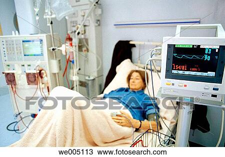 Stock Image - Patient monitored by electronic sphygmomanometer during dialysis session. Fotosearch