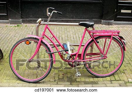 Stock Image - Pink bike in street. Amsterdam. Holland. Fotosearch