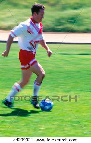 Soccer player kicks the ball View Large Photo Image Stock Image - Soccer player kicks the ball. Fotosearch