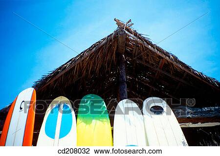 Stock Image - Surfboards leaning on a hut at the beach. Fotosearch