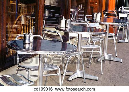 Tables on footpath outside coffee shop View Large Photo Image Stock Photograph - Tables on footpath outside coffee shop. Fotosearch