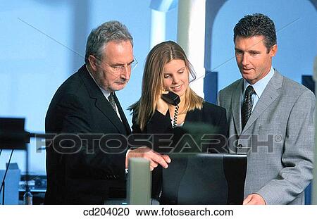 Three businesspeople, businesswoman talking on phone View Large Photo Image Stock Image - Three businesspeople, businesswoman talking on phone. Fotosearch