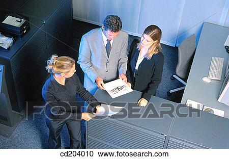Three businesspeople looking on files View Large Photo Image Stock Image - Three businesspeople looking on files. Fotosearch
