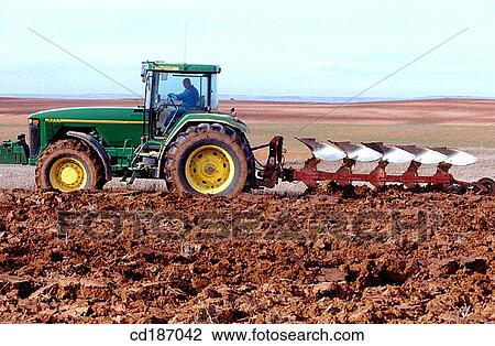 Tractor dragging a plough View Large Photo Image Stock Image - Tractor dragging a plough. Fotosearch