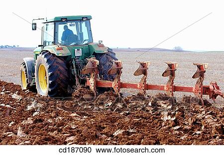 Tractor dragging a plough View Large Photo Image Stock Image - Tractor dragging a plough. Fotosearch