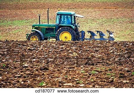 Tractor dragging a plough View Large Photo Image Stock Photo - Tractor dragging a plough. Fotosearch