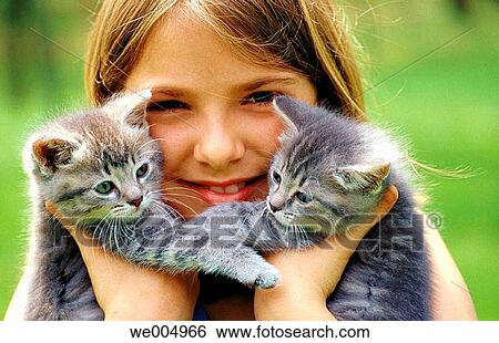 Stock Photograph - Twin kittens with young girl, 10 yrs. Old. Fotosearch