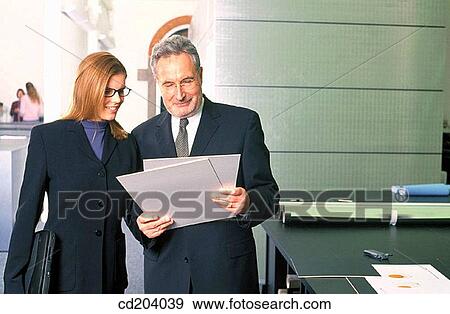 Stock Photo - Two executives looking at files. Fotosearch