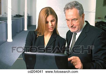 Two executives with laptop View Large Photo Image Stock Image - Two executives with laptop. Fotosearch