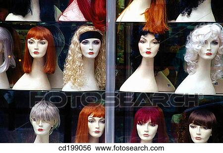 Stock Photograph - Wigs displayed in shop window. Fotosearch