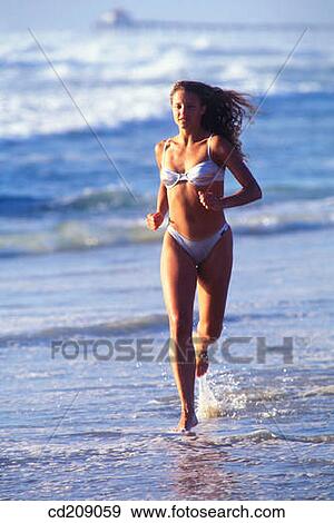 Woman running on the beach View Large Photo Image Stock Photo - Woman running on the beach. Fotosearch