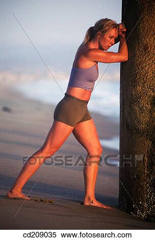 Woman stretching on the beach View Large Photo Image Stock Photography - Woman stretching on the beach. Fotosearch