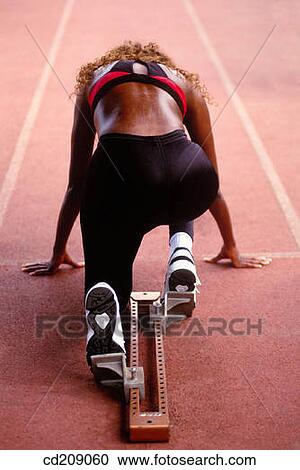 Woman track runner getting ready for a race View Large Photo Image Stock Image - Woman track runner getting ready for a race. Fotosearch