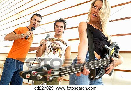 Stock Photo - adolescence, boy, Bass guitar, band, 20's. Fotosearch