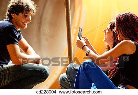 Picture - adolescence, cell phone, boy, 20's. Fotosearch