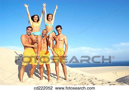 Stock Image - Arms raised, blue, beach, bathing-suit, amusement. Fotosearch