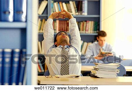 Stock Image - Arms raised, business, bookcase, book, 20's. Fotosearch