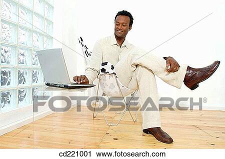 Stock Image - Black business man, working, computer. Fotosearch