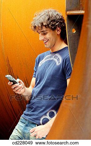 Stock Photo - blond, cell phone, boy, adolescence. Fotosearch