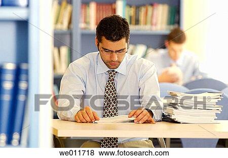 Stock Photo - book, businessman, business, bookcase, 20's. Fotosearch