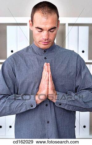 Stock Photo - Businessman practicing yoga. Fotosearch