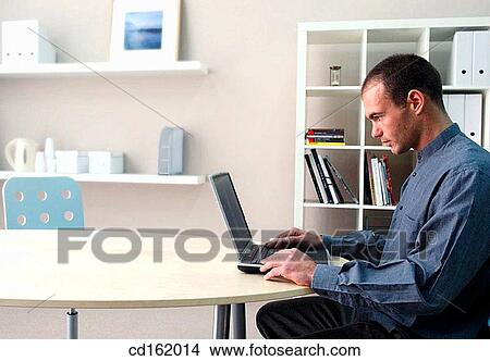 Picture - Businessman working with laptop. Fotosearch