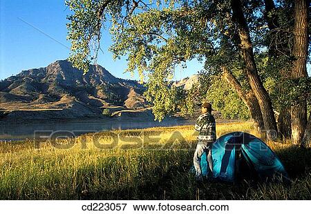 Campsite on the river with a man shivering in a cold morning, Missouri River, Missouri Breaks National Monument, Blaine County, Northern Montana, USA View Large Photo Image Stock Photo - Campsite on the river with a man shivering in a cold morning, Missouri River, Missouri Breaks National Monument, Blaine County, Northern Montana, USA. Fotosearch