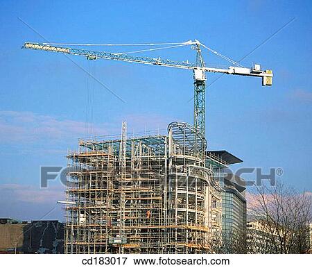 Construction crane and office block under construction View Large Photo Image Stock Photo - Construction crane and office block under construction. Fotosearch
