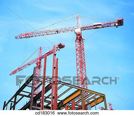 Construction cranes and office block under construction View Large Photo Image Stock Photograph - Construction cranes and office block under construction. Fotosearch