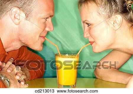 Couple drinking orange juice View Large Photo Image Stock Image - Couple drinking orange juice. Fotosearch