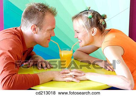 Stock Photo - Couple drinking orange juice. Fotosearch