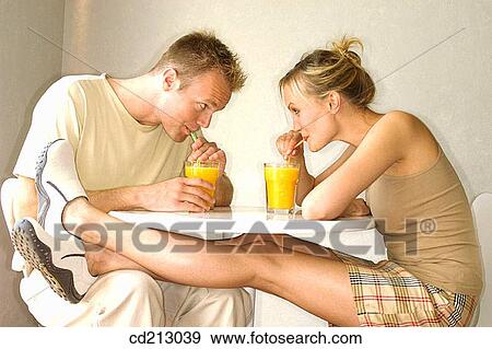 Couple drinking orange juice View Large Photo Image Stock Photo - Couple drinking orange juice. Fotosearch