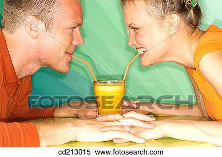 Couple drinking orange juice View Large Photo Image Stock Photography - Couple drinking orange juice. Fotosearch