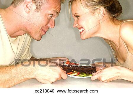 Couple fighting for a cake View Large Photo Image Stock Image - Couple fighting for a cake. Fotosearch