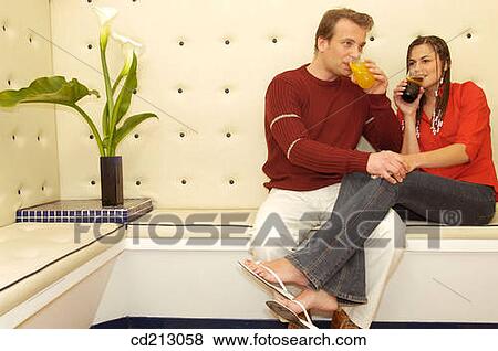 Couple having drink View Large Photo Image Stock Photo - Couple having drink. Fotosearch