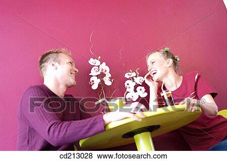 Couple socializing in a bar View Large Photo Image Stock Photo - Couple socializing in a bar. Fotosearch