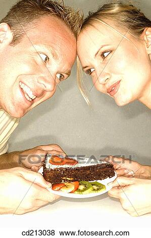 Couple with cake View Large Photo Image Stock Photo - Couple with cake. Fotosearch