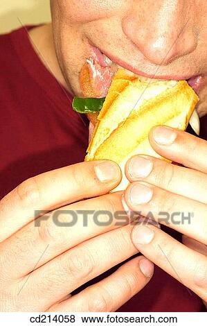 Man biting sandwich, detail View Large Photo Image Stock Photo - Man biting sandwich, detail. Fotosearch