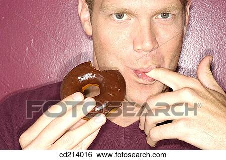 Man eating donut View Large Photo Image Stock Photograph - Man eating donut. Fotosearch