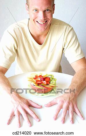 Man eating fruit salad View Large Photo Image Stock Image - Man eating fruit salad. Fotosearch