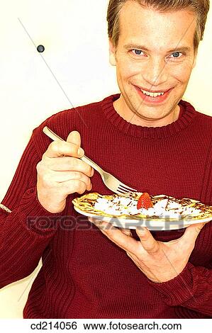 Man eating sweet crepe View Large Photo Image Stock Photograph - Man eating sweet crepe. Fotosearch