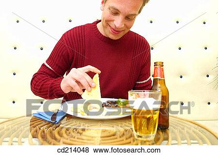 Man having lunch View Large Photo Image Stock Photo - Man having lunch. Fotosearch
