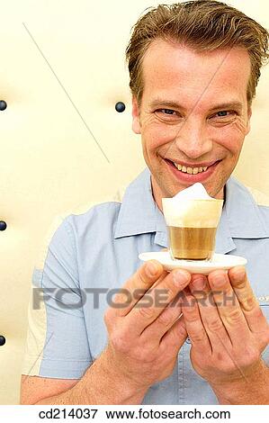 Man holding coffee View Large Photo Image Stock Photo - Man holding coffee. Fotosearch