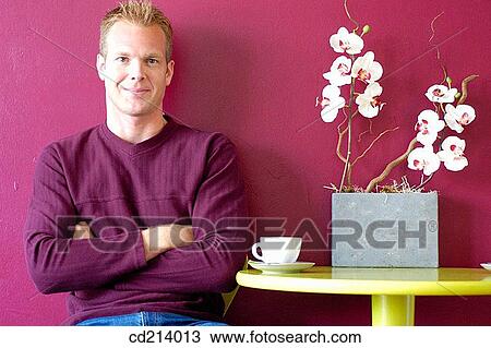 Stock Image - Man relaxing in cafe. Fotosearch