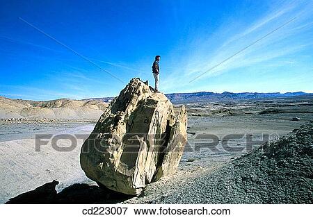 Man standing on rock, Glen Canyon Area, Utah, USA View Large Photo Image Stock Photo - Man standing on rock, Glen Canyon Area, Utah, USA. Fotosearch